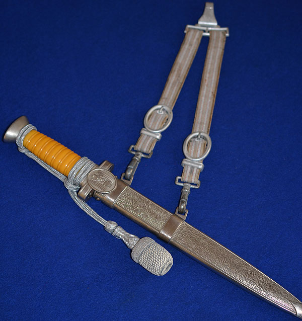 RED CROSS LEADERS DAGGER WITH STRAPS AND KNOT.