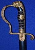 ARMY OFFICERS SWORD WITH LIONS HEAD HILT BY WKC IN MINT CONDITION.