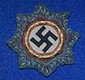 GERMAN CROSS IN GOLD, CLOTH  EXAMPLE ON ARMY / WAFFEN SS FIELD GRAY BACKING.