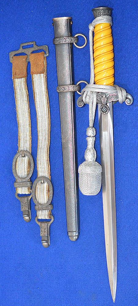 ARMY OFFICERS DAGGER COMPLETE WITH STRAPS AND KNOT.