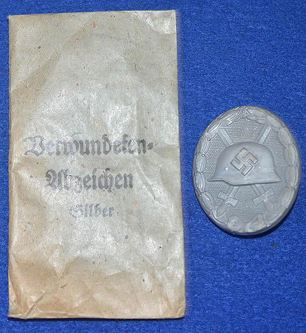 THIRD REICH WOUND BADGE IN SILVER WITH ISSUE PACKET.