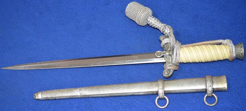 GERMAN ARMY OFFICERS DAGGER BY ALCOSO WITH HIGH LIFT CROSSGUARD DESIGN AND COMPLETE WITH KNOT.