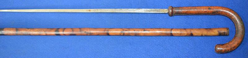 EDWARDIAN SWORD STICK WITH LEATHER HANDLE AND DOUBLE ETCHED BLADE.