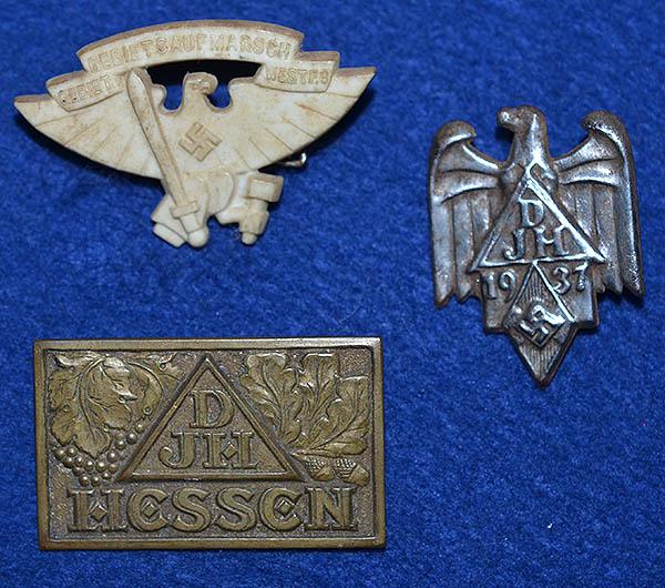 SET OF THREE HITLER YOUTH RALLY BADGES.