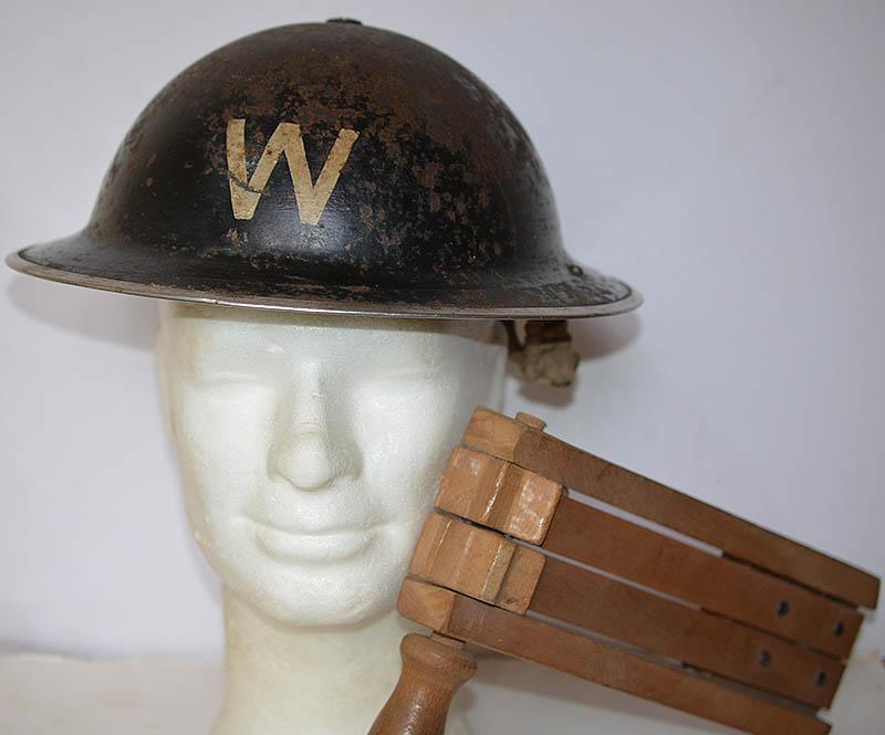 BRITISH WW2 AIR RAID WARDENS HELMET AND GAS ATTACK WOODEN RATTLE.