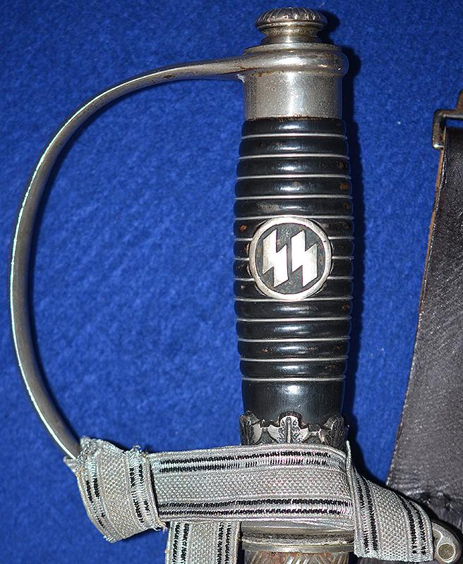 SS OFFICERS SWORD BY KREBS COMPLETE WITH SS KNOT AND BLACK LEATHER HANGER.