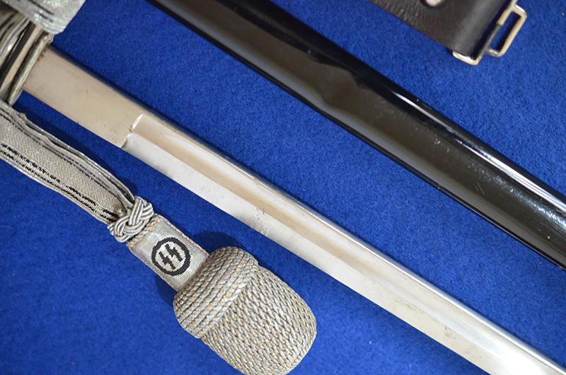 SS OFFICERS SWORD BY KREBS COMPLETE WITH SS KNOT AND BLACK LEATHER HANGER.