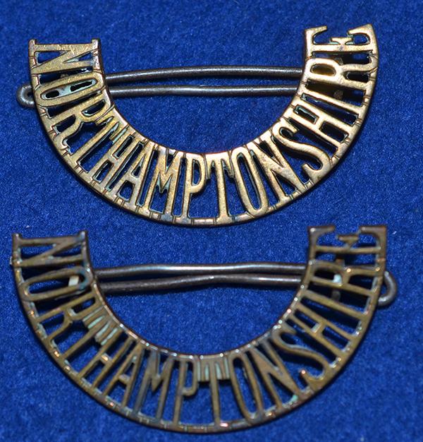 PAIR OF WW1 NORTHAMPTONSHIRE REGIMENT SHOULDER TITLES.
