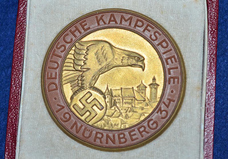 NSDAP 1934 COMEMORATIVE PLAQUETTE FOR THE NURNBERG RALLY COMPETITIONS WITH ORIGINAL PRESENTATION BOX.