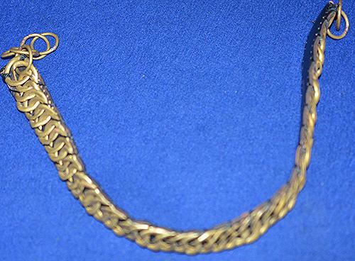 BRITISH BRASS AND LEATHER HELMET CHIN STRAP.