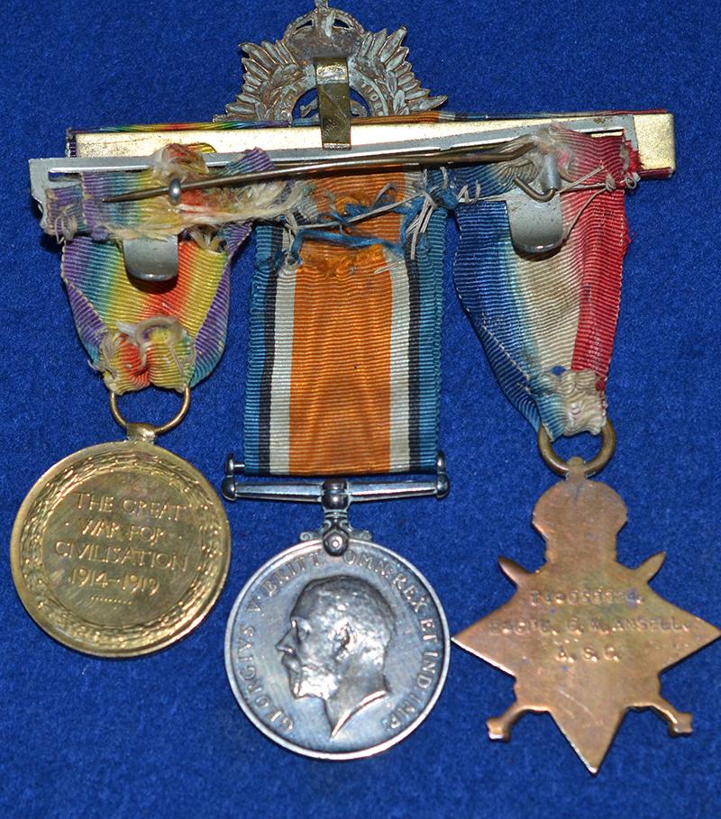 SET OF THREE WW1 BRITISH MEDALS COMPLETE WITH THE OWNERS CAP BADGE.