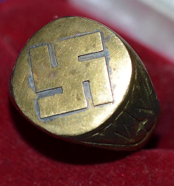 SWASTIKA DECORATED FINGER RING.