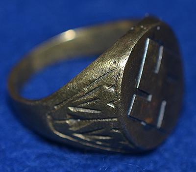 SWASTIKA DECORATED FINGER RING.