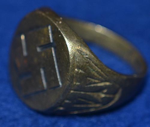 SWASTIKA DECORATED FINGER RING.