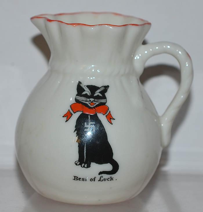 BRITISH CREAM JUG DEPICTING A CAT DECORATED WITH SWASTIKA.