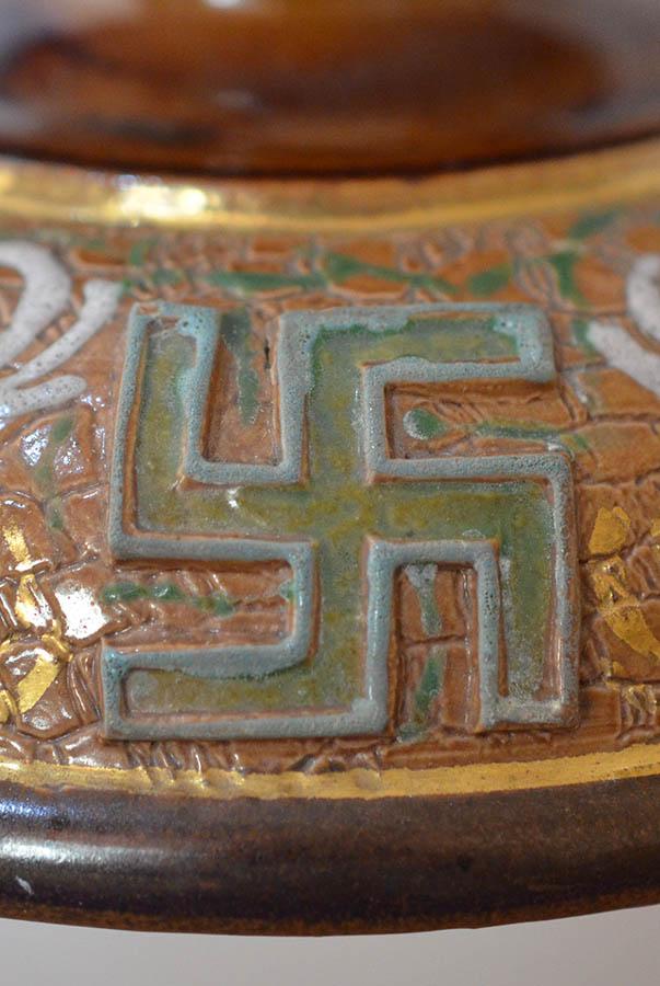 ENGLISH SWASTIKA DECORATED POTTERY MATCH STRIKER BY DOULTON.