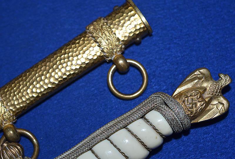 THIRD REICH NAVAL DAGGER WITH HAMMERED SCABBARD AND PLAIN BLADE, COMPLETE WITH GOLD KNOT.